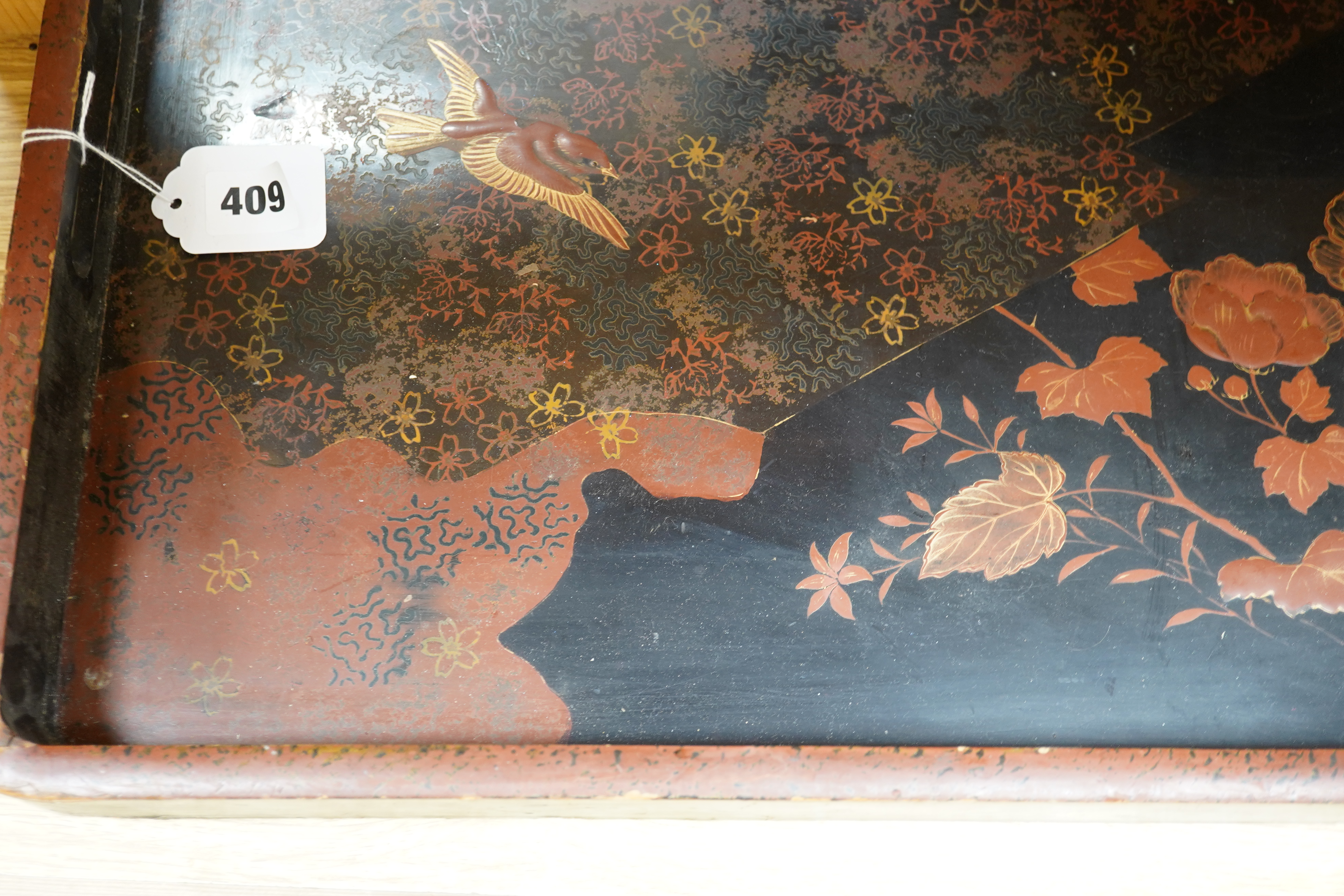 Three trays to include a butterfly wing example and a Japanese lacquered example decorated with birds and flowers, 75cm wide. Condition - poor to fair